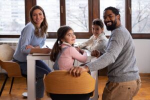 side-view-family-sitting-table (1)